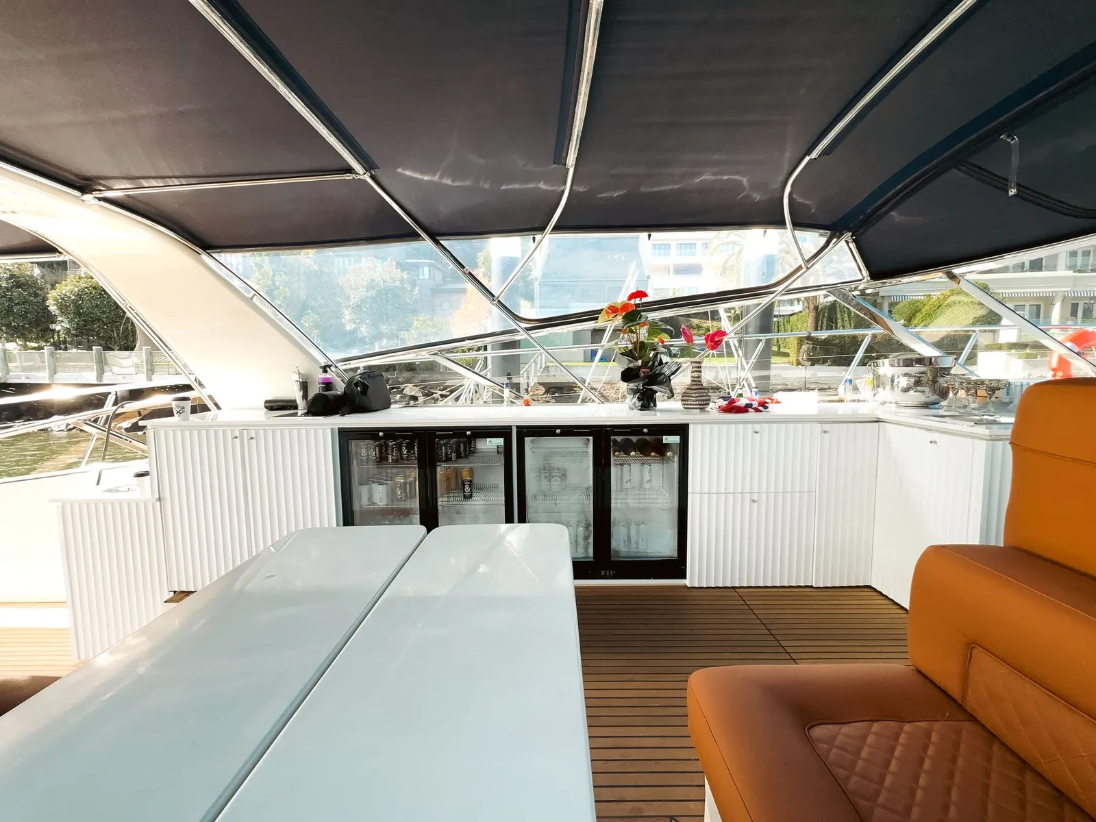 Deck dining setting with tan leather seating on Bote Charters