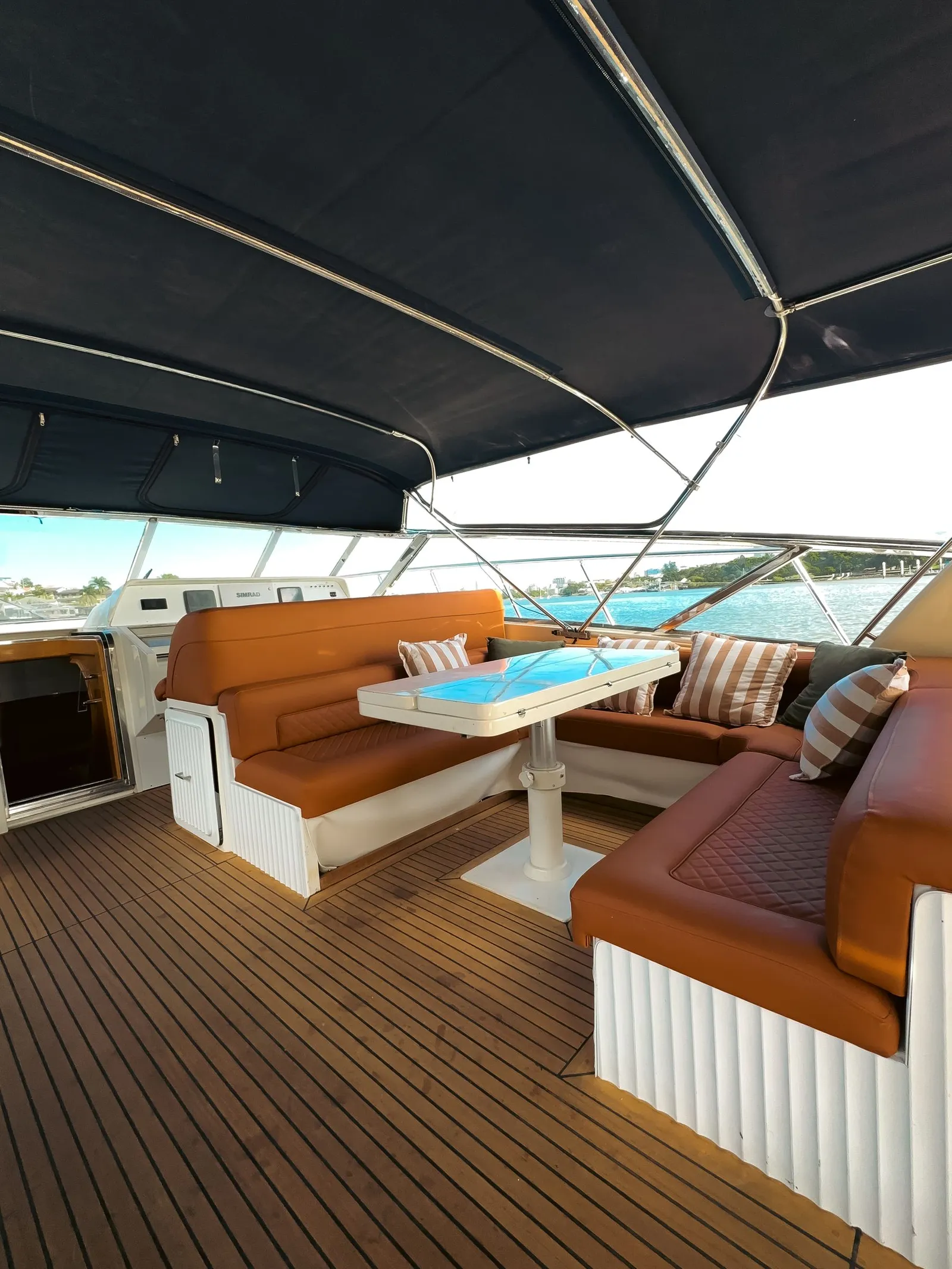 Shaded deck lounge on the Bote Charters yacht at dusk