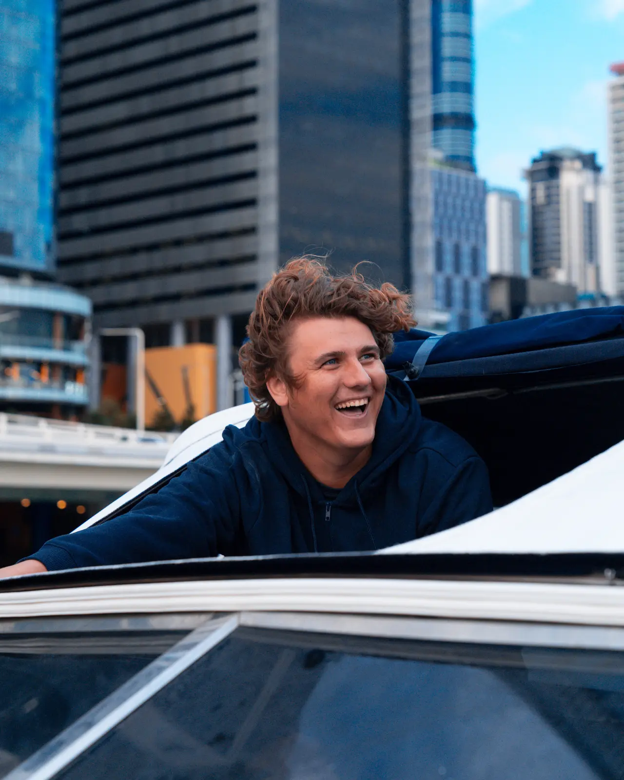 A guest laughing and celebrating aboard the Bote Charters yacht