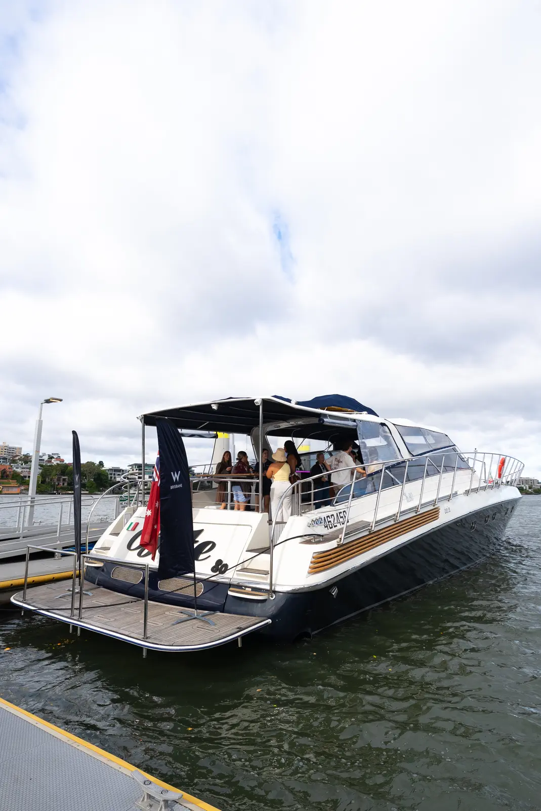 Guests gathering and celebrating on the stern of the Bote Charters yacht