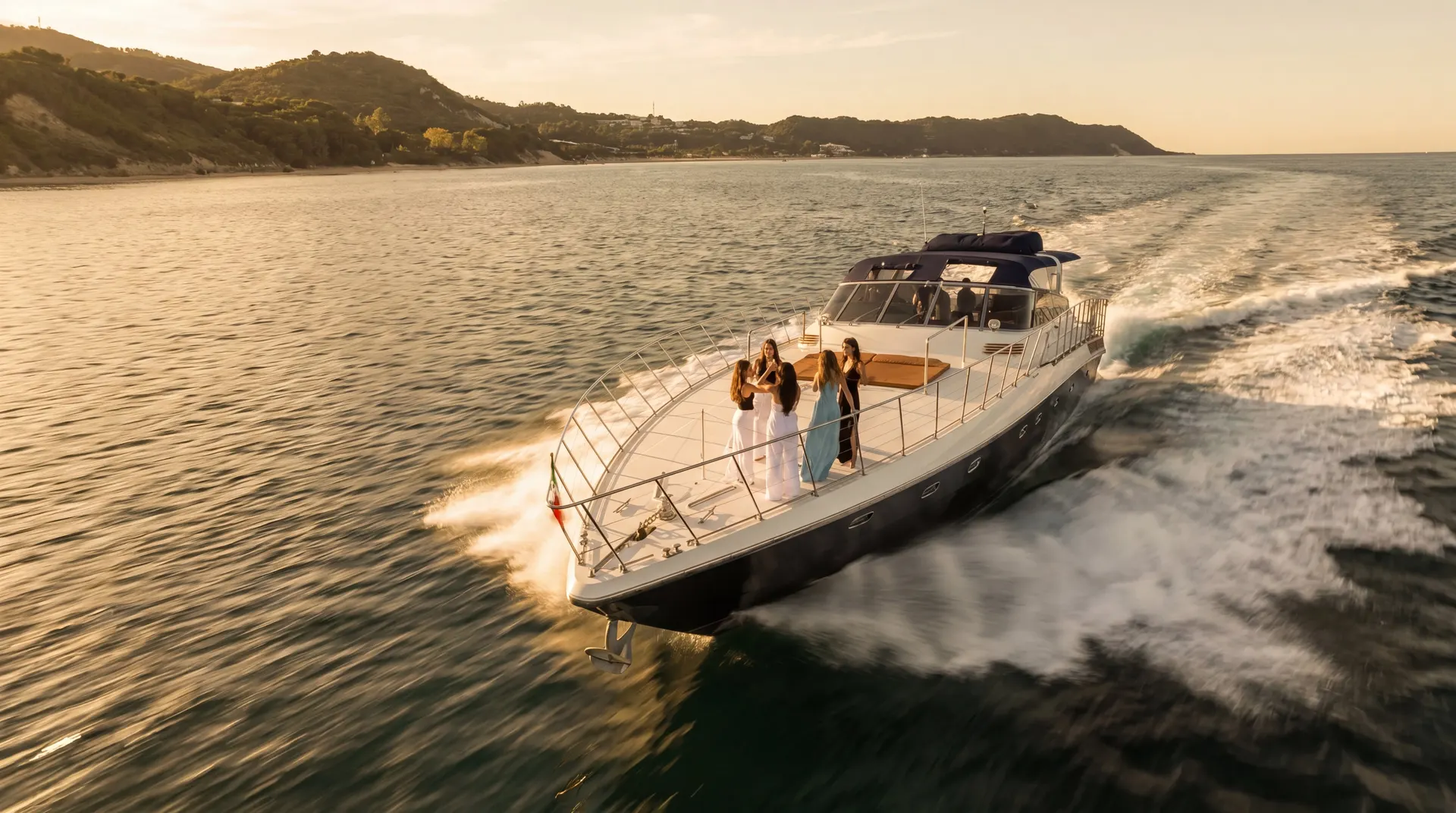 Cinematic view of the Bote Charters yacht cruising at golden hour